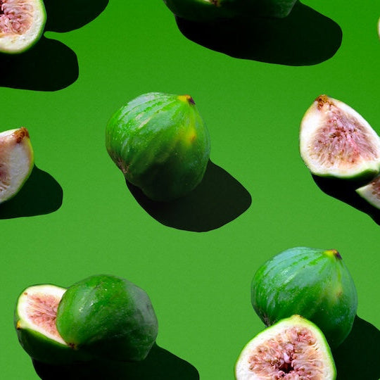 Figs and fig slices on a green background